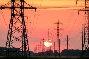 silhouette of electric post during sunset